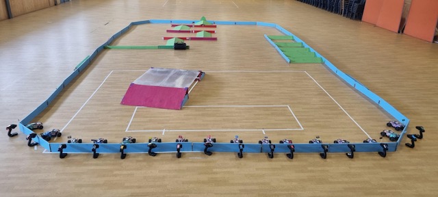 Setup scene: crew assembling the portable arena at a school hall